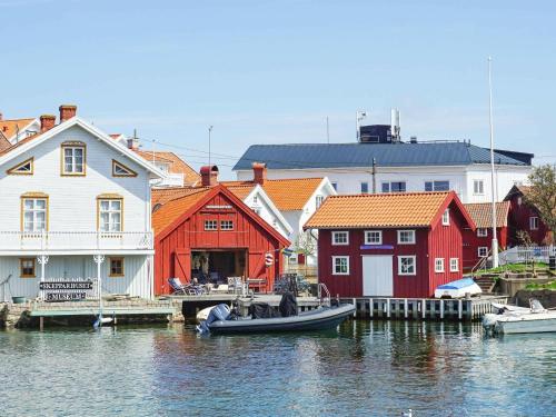 a group of houses and a boat in the water at Holiday home Gullholmen in Gullholmen
