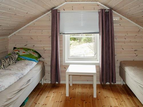 a small bedroom with a bed and a window at 6 person holiday home in Dønna in DÃ¸nnes