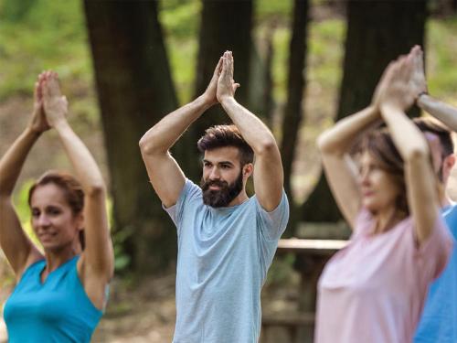 a group of people doing yoga in the woods at UCLA Lake Arrowhead Lodge in Lake Arrowhead
