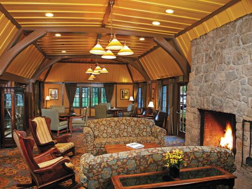 a living room with a couch and a fireplace at UCLA Lake Arrowhead Lodge in Lake Arrowhead