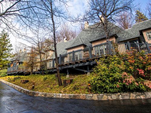 a house with a deck on the side of a street at UCLA Lake Arrowhead Lodge in Lake Arrowhead