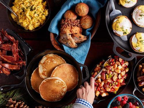 a person is reaching for a plate of breakfast foods at UCLA Lake Arrowhead Lodge in Lake Arrowhead
