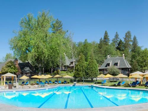 a large pool at a resort with chairs and umbrellas at UCLA Lake Arrowhead Lodge in Lake Arrowhead