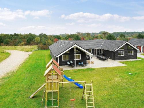 an aerial view of a house with a playground at 20 person holiday home in Grenaa in Grenå