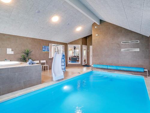 a large swimming pool with a tub and a sink at 20 person holiday home in Grenaa in Grenå