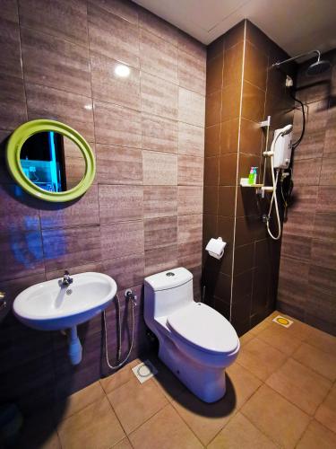 a bathroom with a toilet and a sink and a mirror at Simfoni Level 39 Superior Designer Studio with 100mbps WiFi & Netflix in Kampong Baharu Balakong