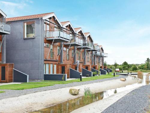 a row of apartment buildings with a body of water at 4 person holiday home in Bogense in Bogense