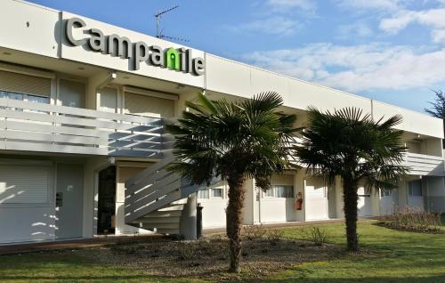 un edificio del campus con dos palmeras delante en Campanile Lyon Nord - Ecully, en Écully