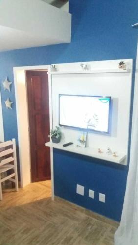 a bathroom with a sink and a blue wall at Village dos Pássaros Apartamento in Guarapari