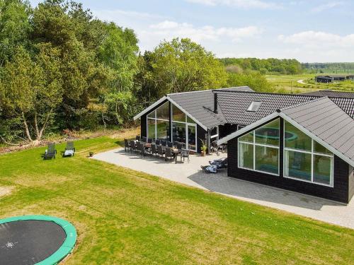 an overhead view of a house with a pool and a yard at 14 person holiday home in Glesborg in Glesborg