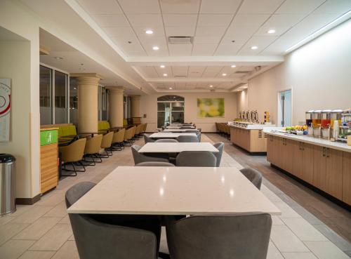 a cafeteria with rows of tables and chairs at Wyndham Garden McAllen at La Plaza Mall in McAllen