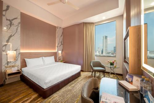 a hotel room with a bed and a desk at Cititel Penang in George Town