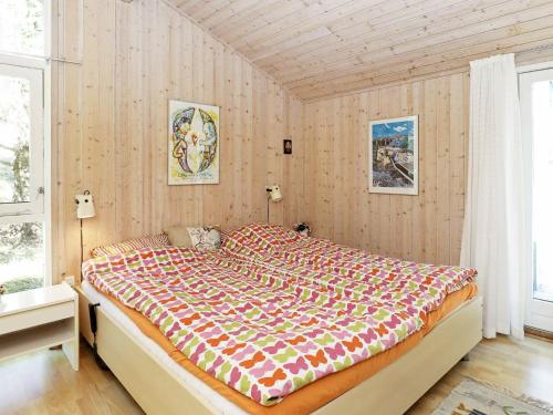 スケーエンにあるHoliday home Skagen XXの木製の壁のベッドルームの大型ベッド1台