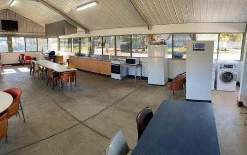 a cafeteria with tables and chairs in a building at Mia Motel in Griffith