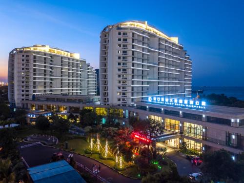 two tall buildings in a city at night at Haikou Bay Hengda Yige Holiday Condo Hotel in Haikou