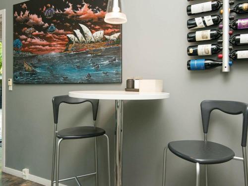 a bar with two stools and a table with a painting at Luxury Spa Retreat in Thorsager - By Traum Ferienwohnungen in Rønde
