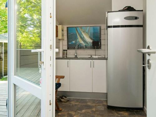 a kitchen with a refrigerator and a sink at Luxury Spa Retreat in Thorsager - By Traum Ferienwohnungen in Rønde