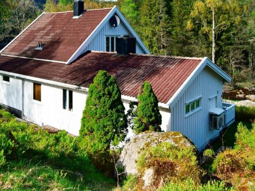 a blue and white house with a brown roof at 8 person holiday home in Lindesnes in Tryland
