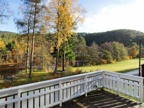 a white bridge with a view of a field and trees at 8 person holiday home in Lindesnes in Tryland