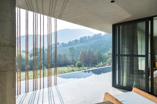 a house with a view of a lake and mountains at Anadu Private House in Huzhou