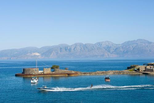 a person on a boat in a large body of water at Elounda Beach Hotel & Villas, a Member of the Leading Hotels of the World in Elounda