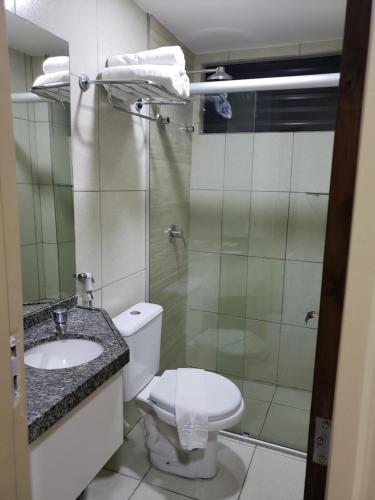 a bathroom with a toilet and a sink and a shower at Villa Park Hotel Fortaleza in Fortaleza
