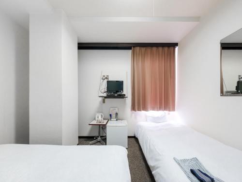 Ένα ή περισσότερα κρεβάτια σε δωμάτιο στο Tabist Hotel Tetora Hakodate Station