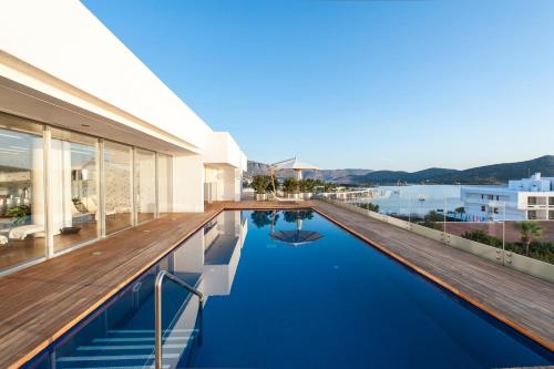 a house with a swimming pool with a view of the water at Elounda Beach Hotel & Villas, a Member of the Leading Hotels of the World in Elounda