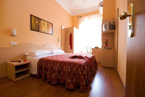 a hotel room with a bed and a window at Hotel Sabatino Milan in Milan