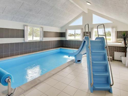 a swimming pool with a slide in a house at 20 person holiday home in Vejby in Vejby