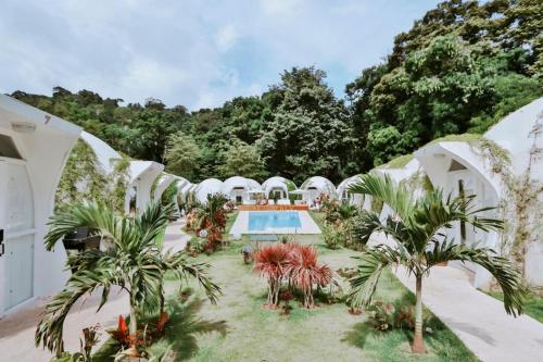 an exterior view of a villa with a swimming pool at Igloo Beach Lodge in Manuel Antonio