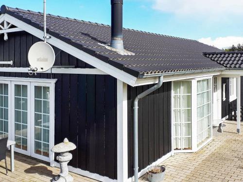 a black house with a black roof at 7 person holiday home in Hemmet in Hemmet