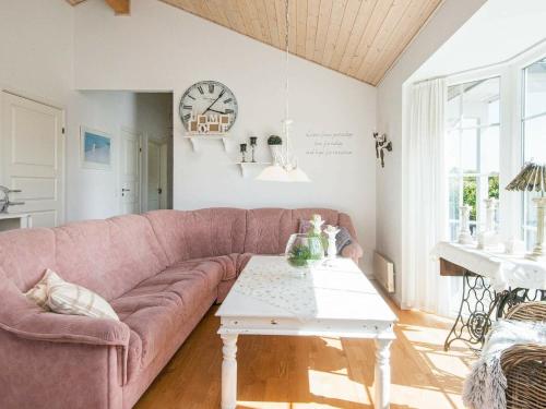 a living room with a pink couch and a table at 7 person holiday home in Hemmet in Hemmet