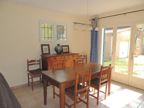 une salle à manger avec une table et des chaises en bois dans l'établissement Holiday Home in Buisson with Private Pool, à Buisson