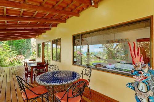 a dining room with a table and chairs on a deck at Anamaya Resort in Montezuma