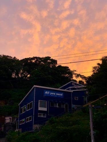 a blue building with an all star meal sign on it at Guesthouse All you need - All rooms have an ocean view! in Shimoda