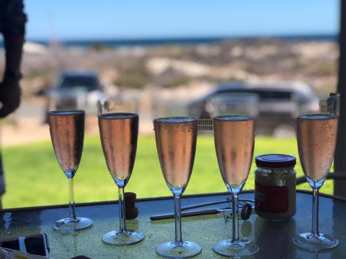 a group of champagne glasses sitting on a table at Family Tides in Wallaroo