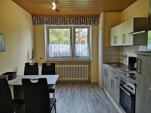 a kitchen with a table and chairs and a window at Ferienwohnung am Schlosspark in Melsungen