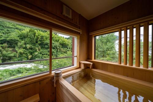 an empty room with windows and a plunge pool at Kakureisen in Saga