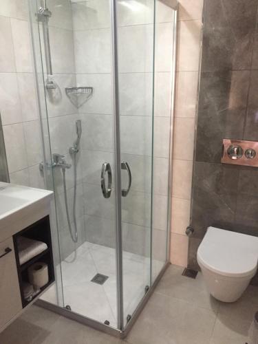 a shower stall in a bathroom with a toilet at Hotel Baylan İzmir in Izmir