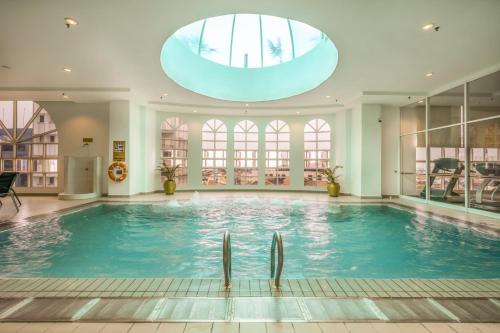 a large swimming pool with a large window at Cititel Penang in George Town