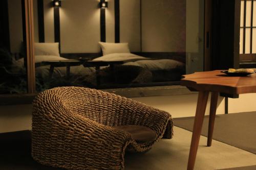 a room with a chair and a table and a mirror at Kakureisen in Saga