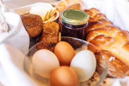 a bunch of different types of bread and eggs at Baumgartnerhof Sauvigon in Cortaccia
