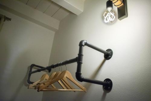 a rack of wooden hangers hanging on a wall at Apartment Charme and Relax with Garden and Swimming Pool in Desenzano del Garda