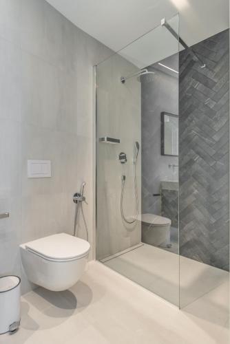 a bathroom with a glass shower and a toilet at Villa Juliet in Trogir