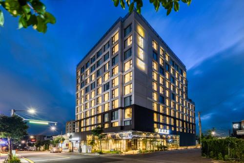 a tall black building with windows at night at Shin Shin Hotel Cheonjiyeon in Seogwipo