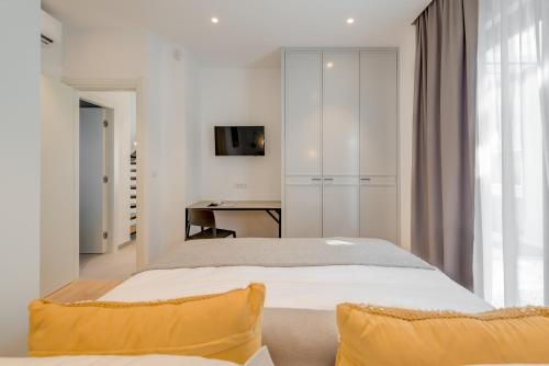 a bedroom with a bed and a desk in it at Villa Juliet in Trogir