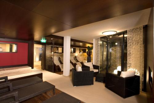 a living room with couches and chairs at stefan Hotel in Sölden