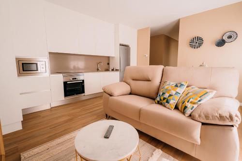 a living room with a couch and a coffee table at Apartamentos Rúa Vella in Caldas de Reis