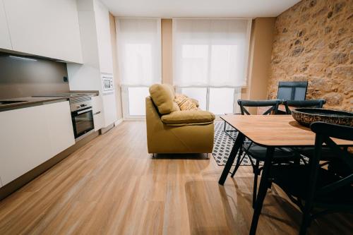 a living room filled with furniture and a kitchen at Apartamentos Rúa Vella in Caldas de Reis